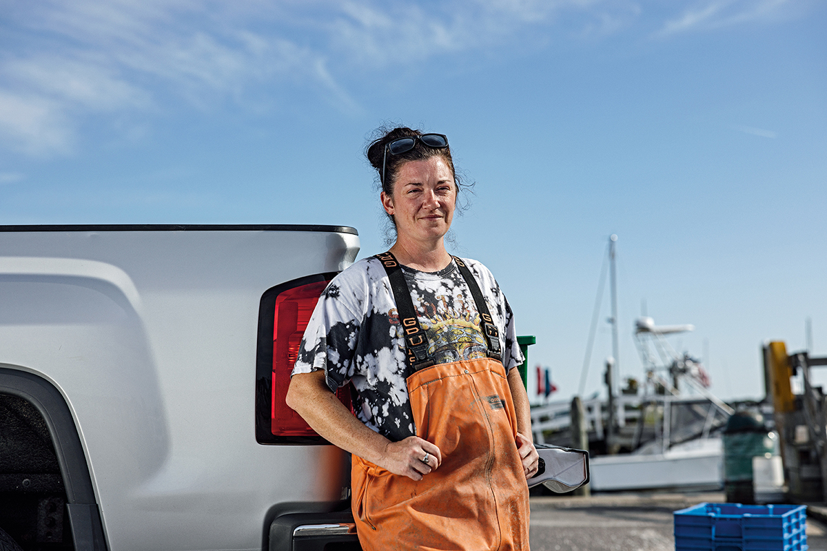 Oyster farmer Natalie O’Conner sits behind her truck at the docks.