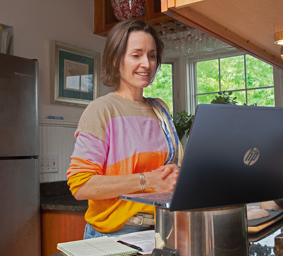 Annie Sherman follows Chef Iwakura on her laptop in her kitchen as he demonstrates filleting fluke for sashimi.