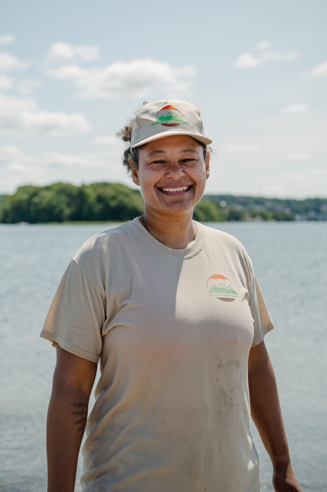 Jo Ayuso takes a moment to smile for the camera on a bright day out on the water.